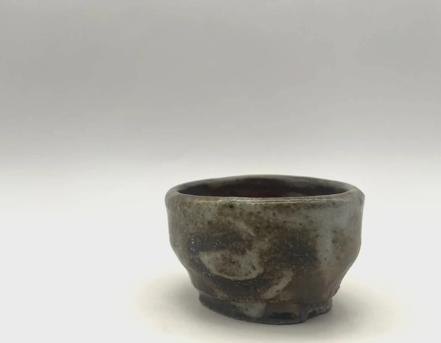 Wood-fired speckle sake cup by Timi Lantos Ceramics