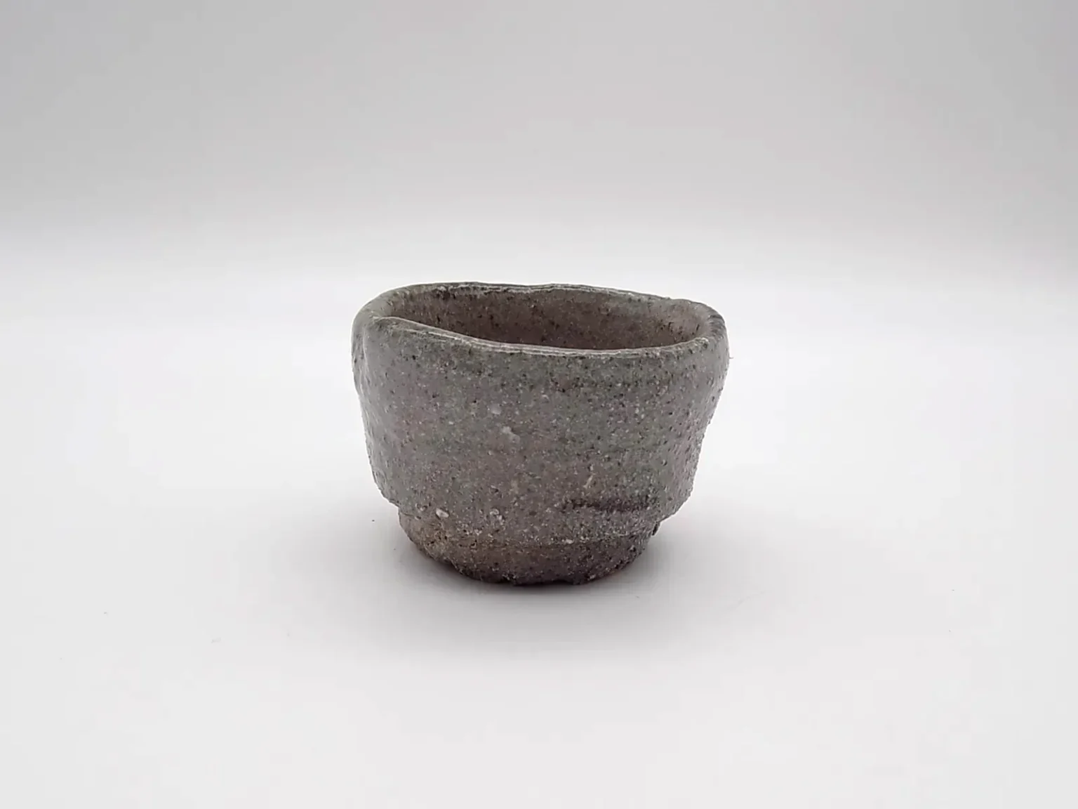 Hand thrown guinomi cup in brown glaze by Timi Lantos Ceramics