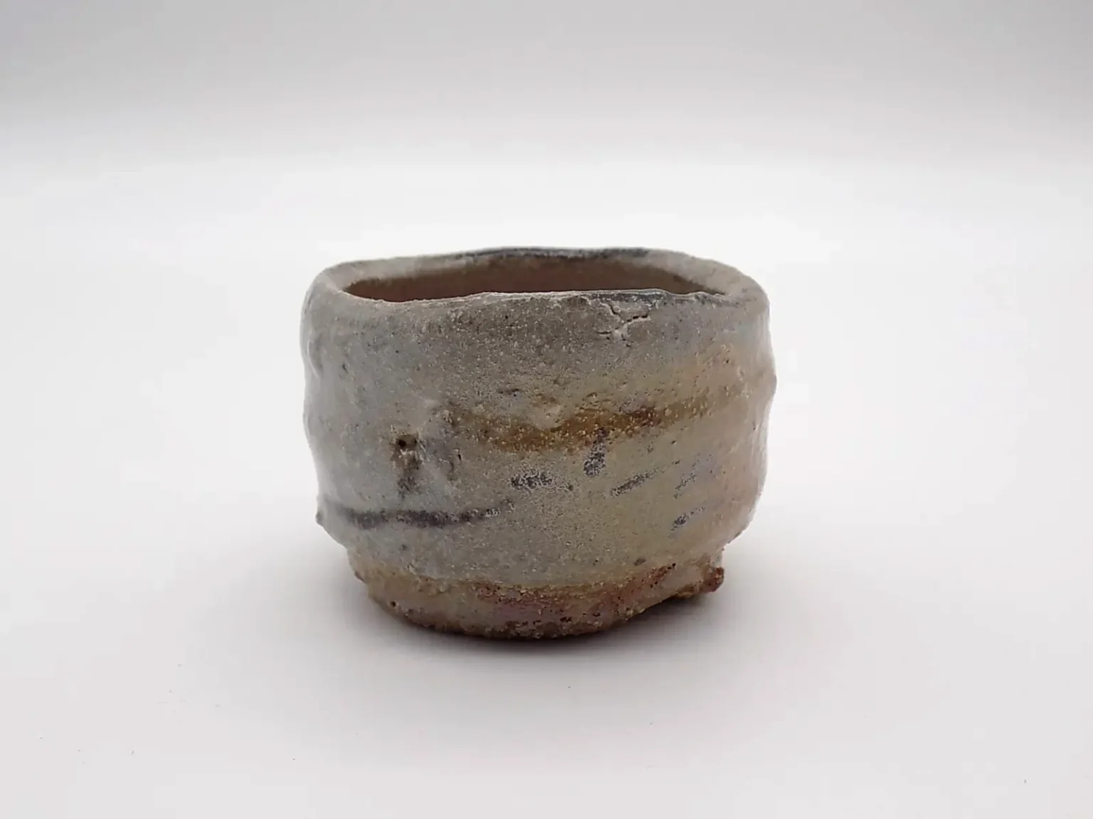 Hand thrown ochoko cup with ash glaze detail by Timi Lantos Ceramics
