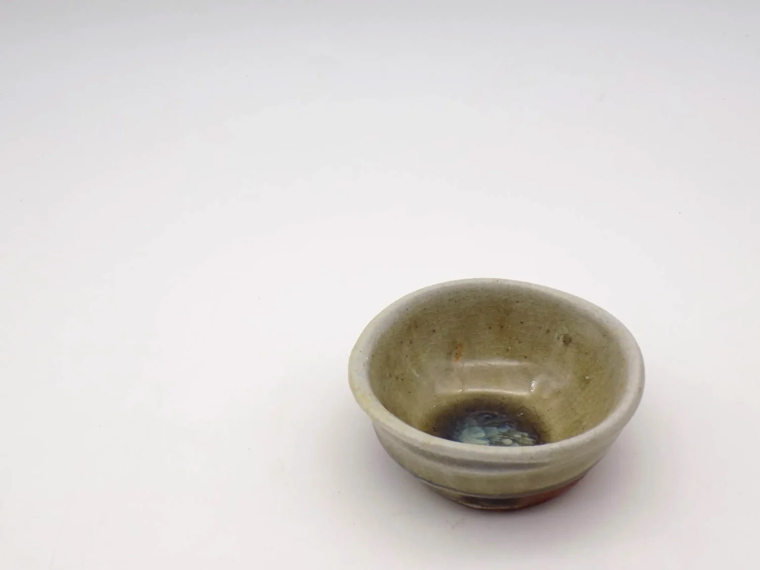 Hand-thrown ochoko with green interior, top view by Timi Lantos Ceramics