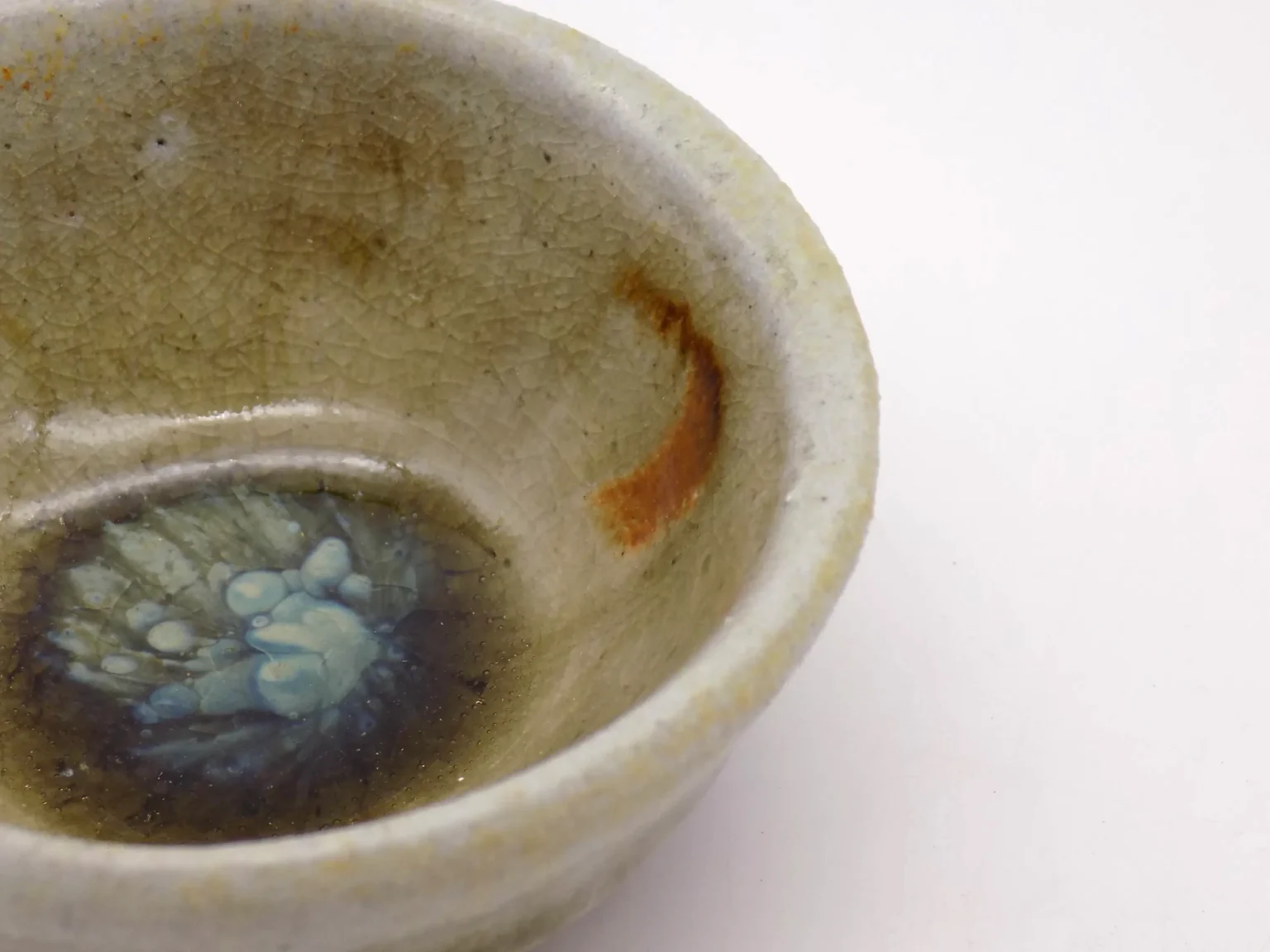 Hand-thrown sake cup with earthy tones, close-up detail by Timi Lantos Ceramics