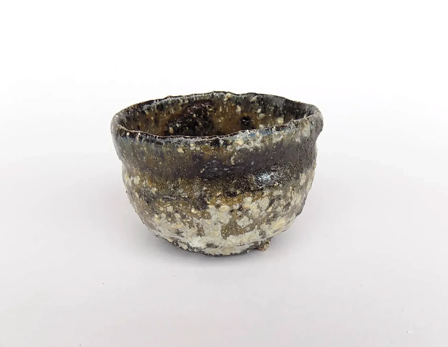 Hand-thrown sake cup with earthy tones, detail by Timi Lantos Ceramics