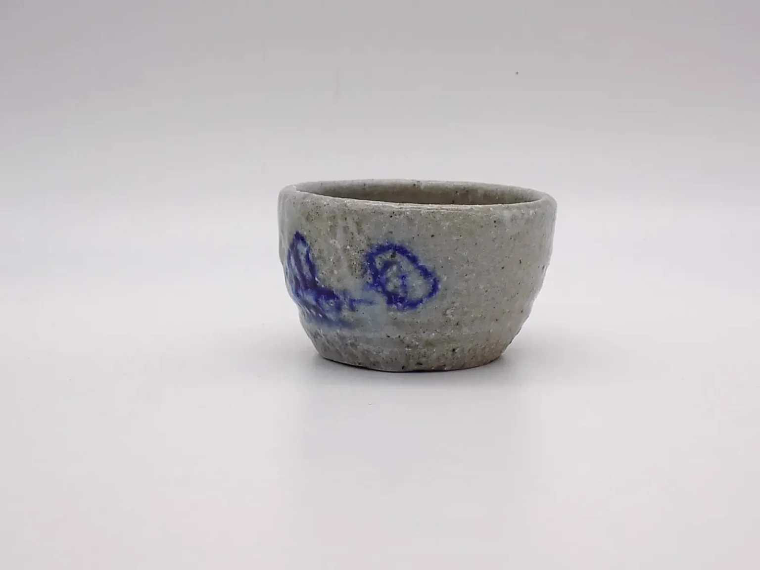 Hand-thrown sake cup with earthy tones, side view by Timi Lantos Ceramics