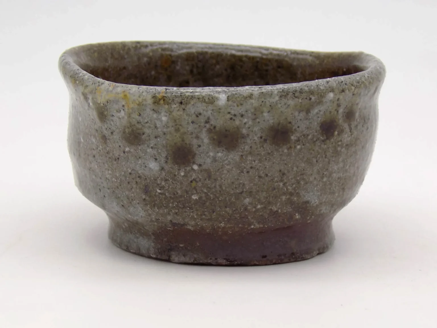 Hand-thrown sake cup with earthy tones, side view by Timi Lantos Ceramics