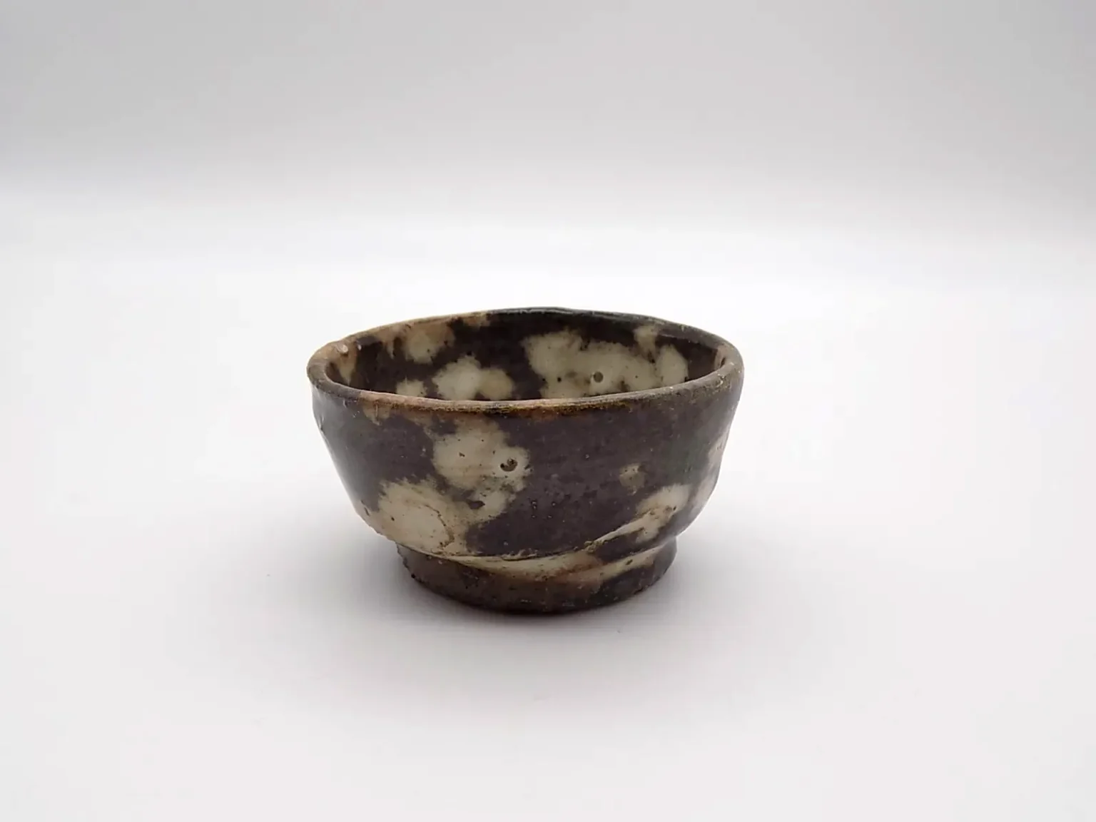 Hand-thrown wabi-sabi sake cup by Timi Lantos Ceramics