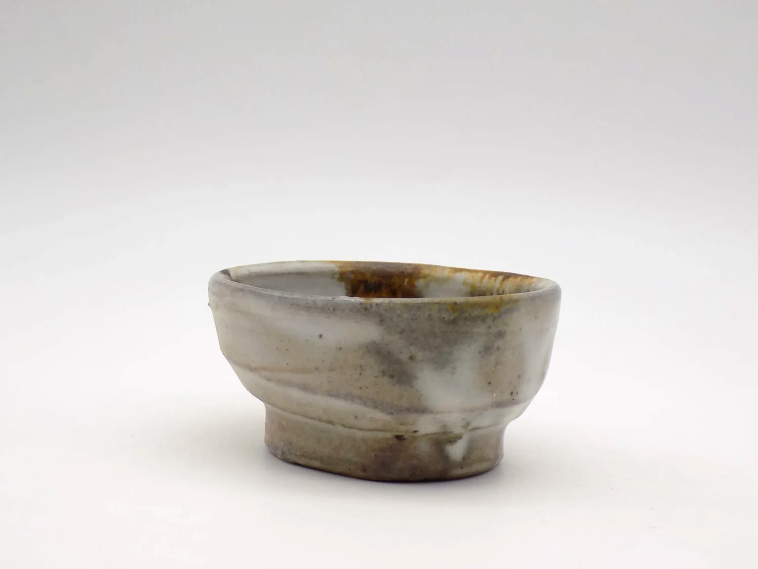 Hand-thrown wabi-sabi sake cup, side view by Timi Lantos Ceramics