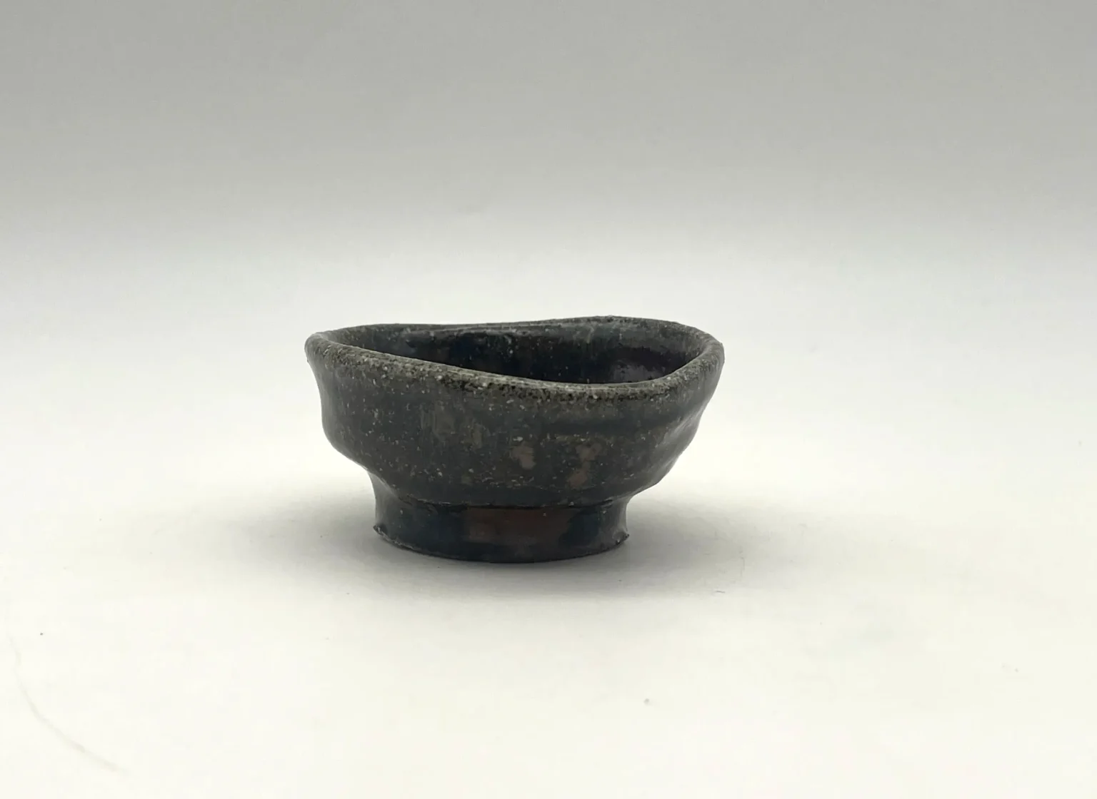 Anagama ochoko with black firecolor effects, side view by Timi Lantos Ceramics