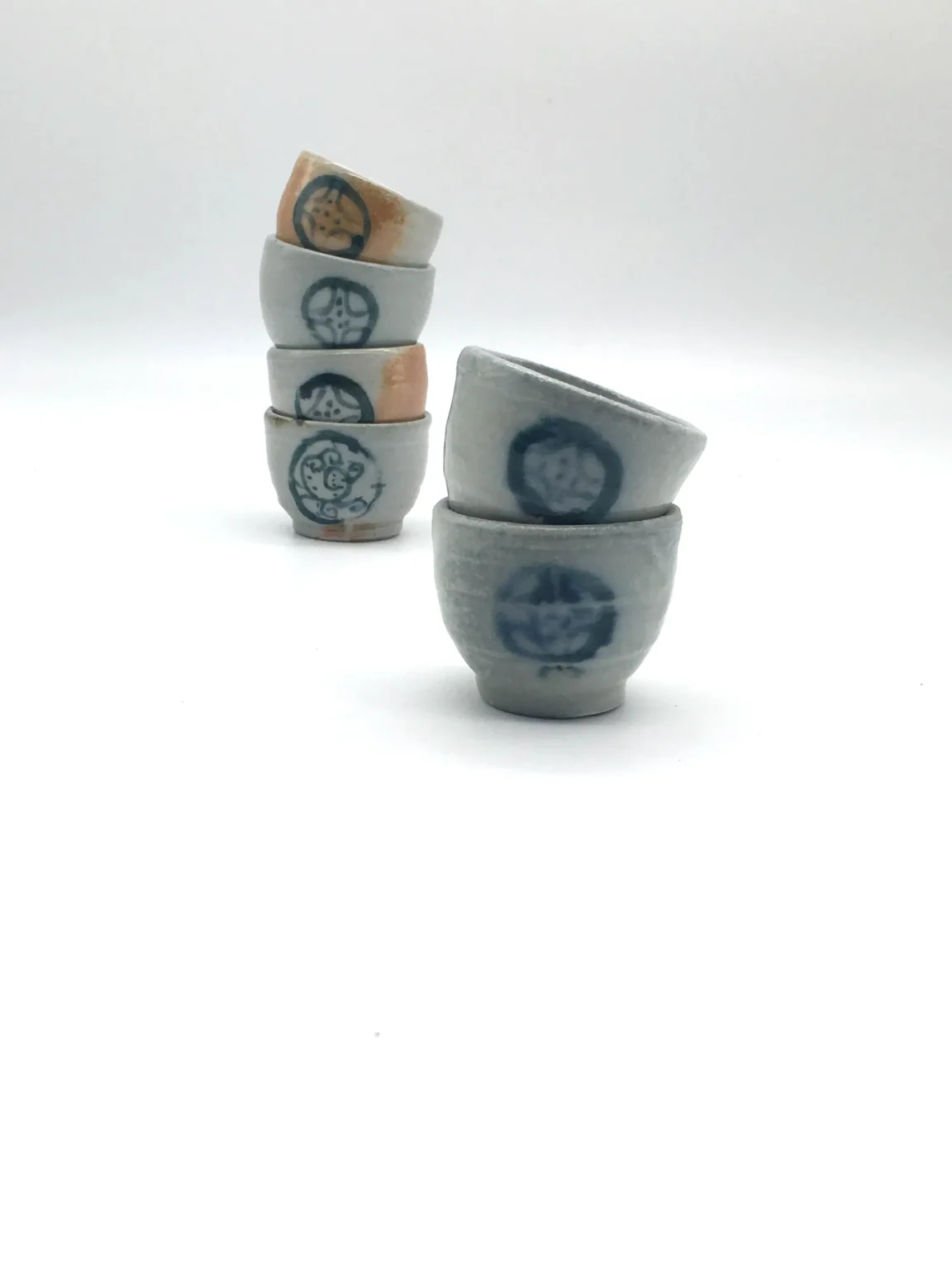 Stacked anagama porcelain earthy ochoko cups by Timi Lantos Ceramics