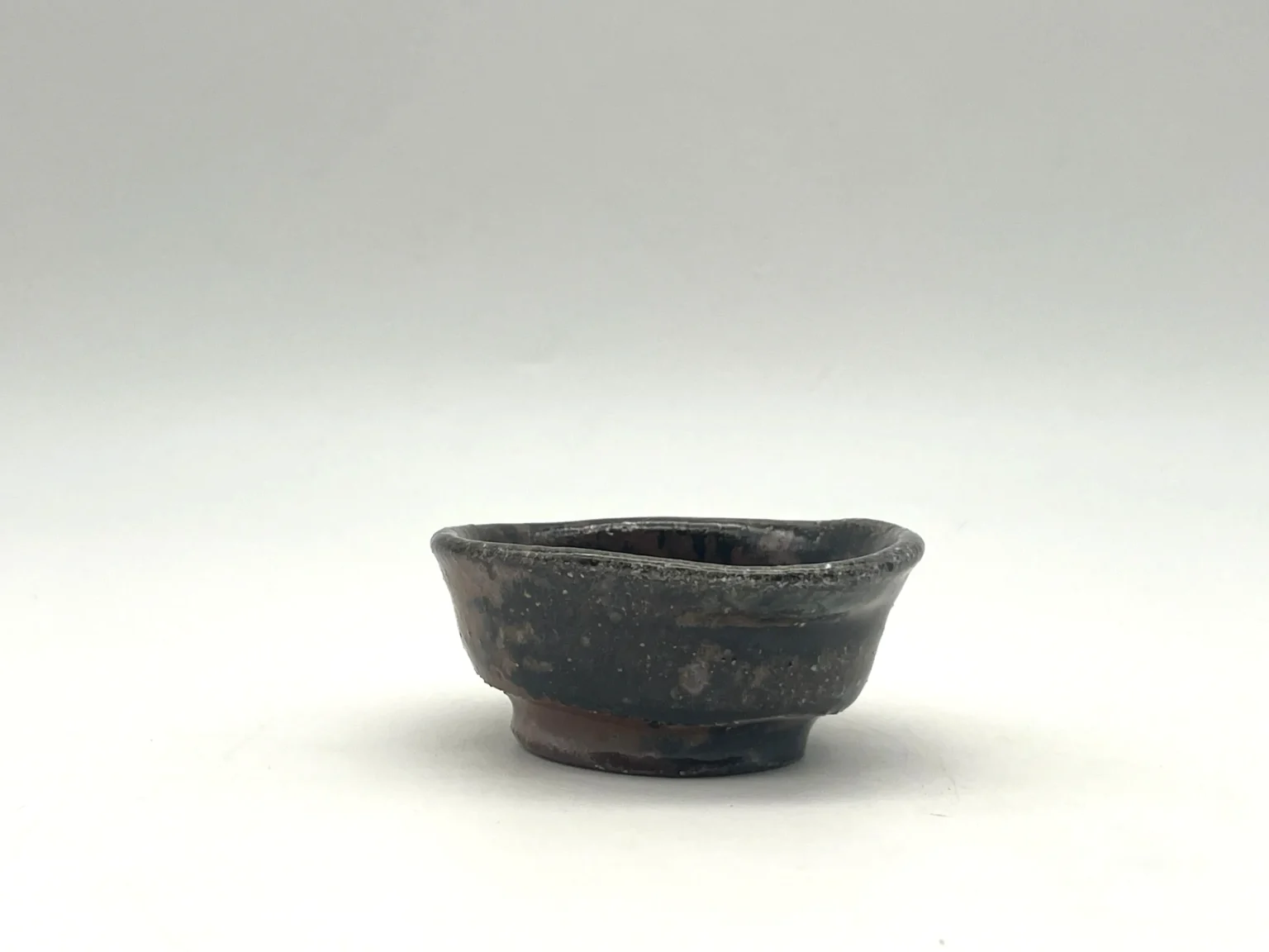 Ochoko with brown ash glaze, side view by Timi Lantos Ceramics