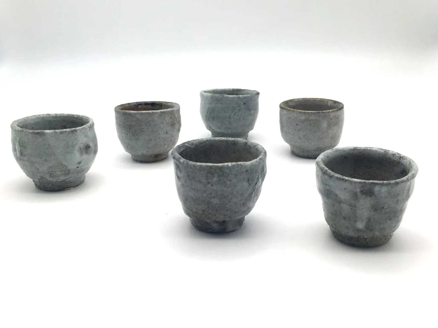 Ochoko cups with carbon trap effect in earthy tones by Timi Lantos Ceramics