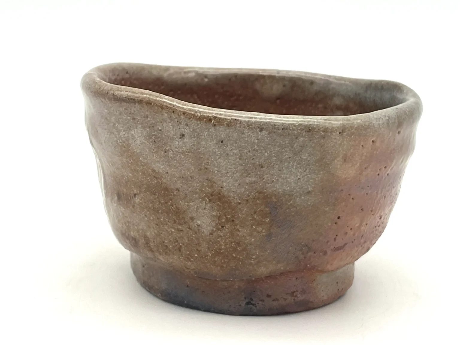 Ochoko with red Shino glaze, side view by Timi Lantos Ceramics