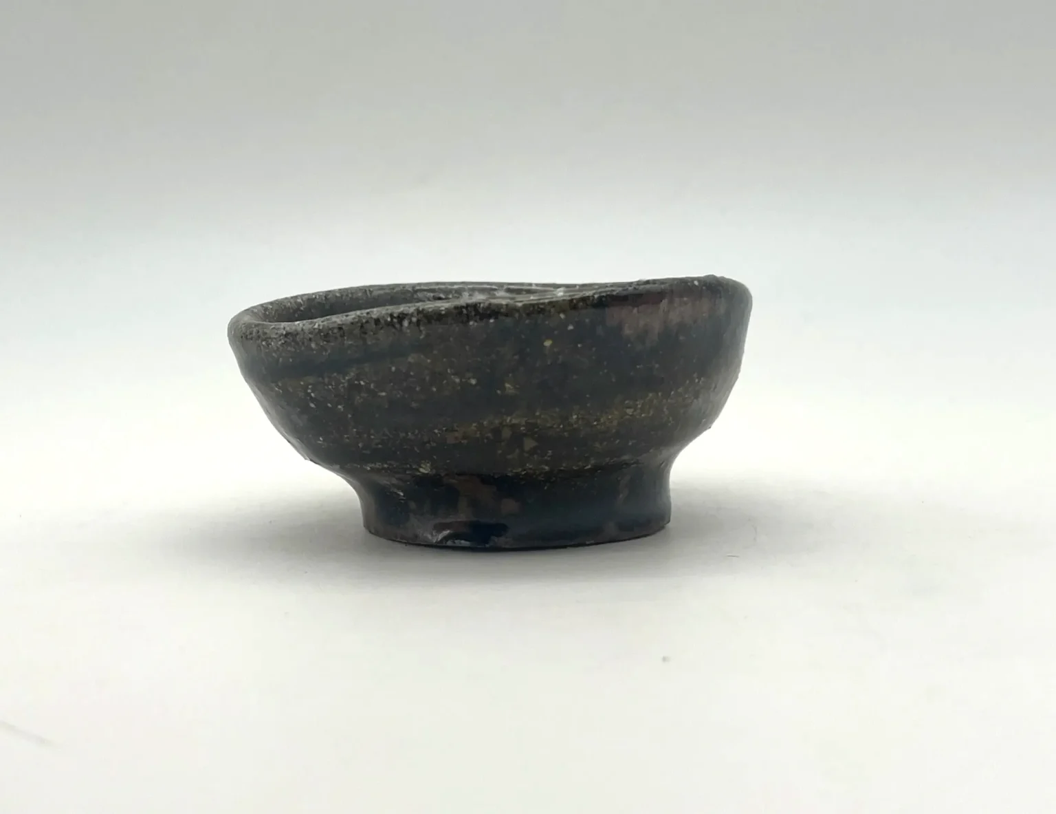 Anagama firecolor black sake cup, side view by Timi Lantos Ceramics