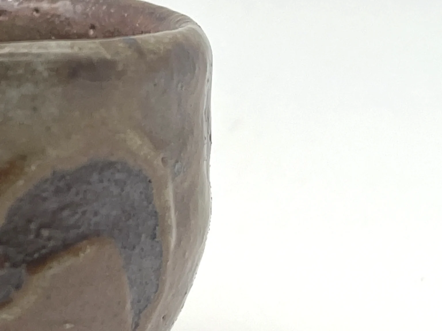 Close-up view of an anagama rustic sake cup by Timi Lantos Ceramics