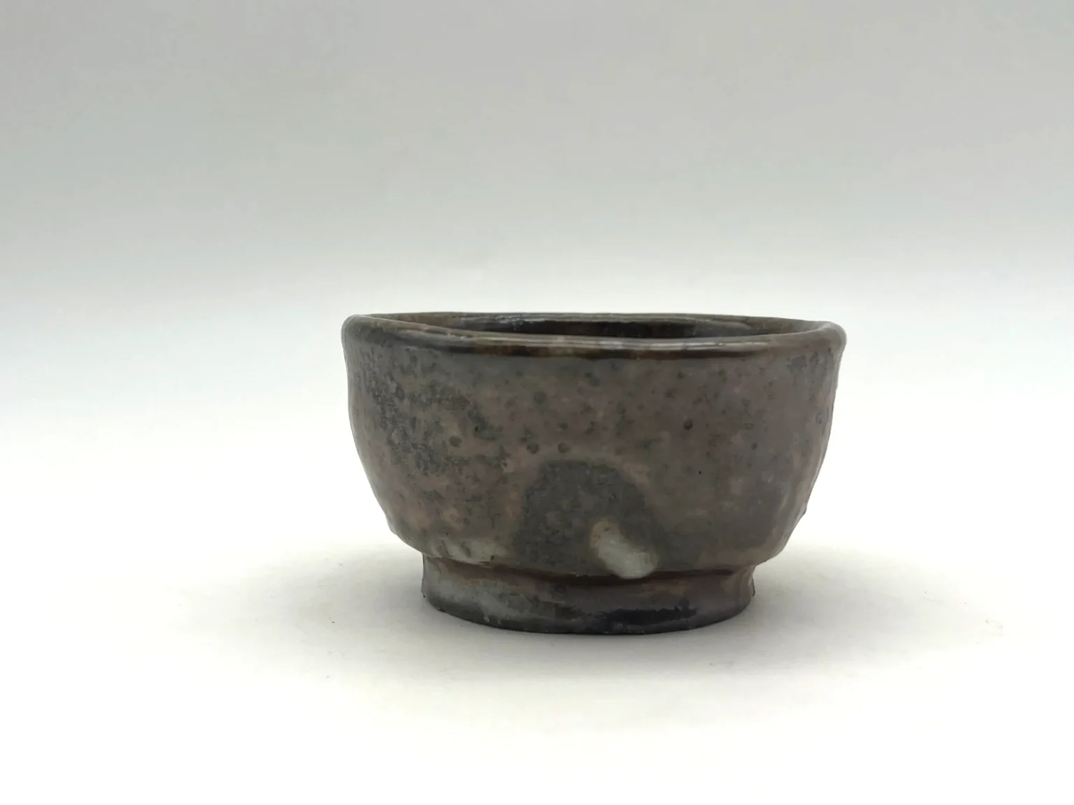 Sake cup with ash feldspar brown glaze by Timi Lantos Ceramics