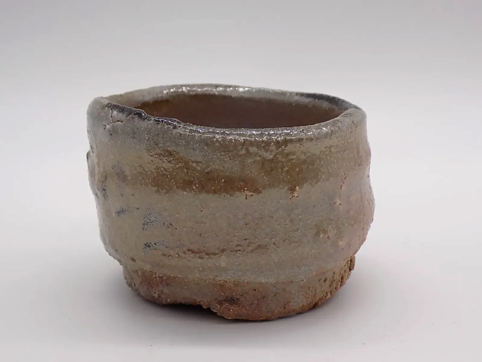 Sake cup with brown ash glaze, bottom view by Timi Lantos Ceramics