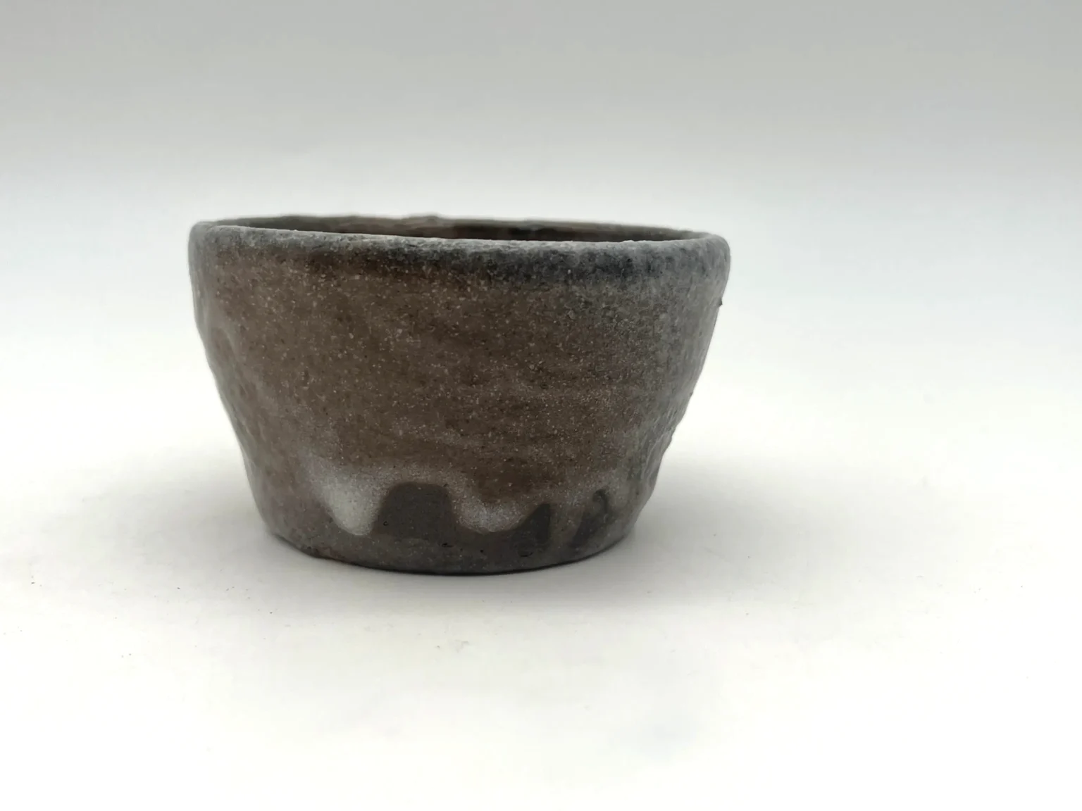 Wood-fired feldspar glaze wabi-sabi sake cup by Timi Lantos Ceramics