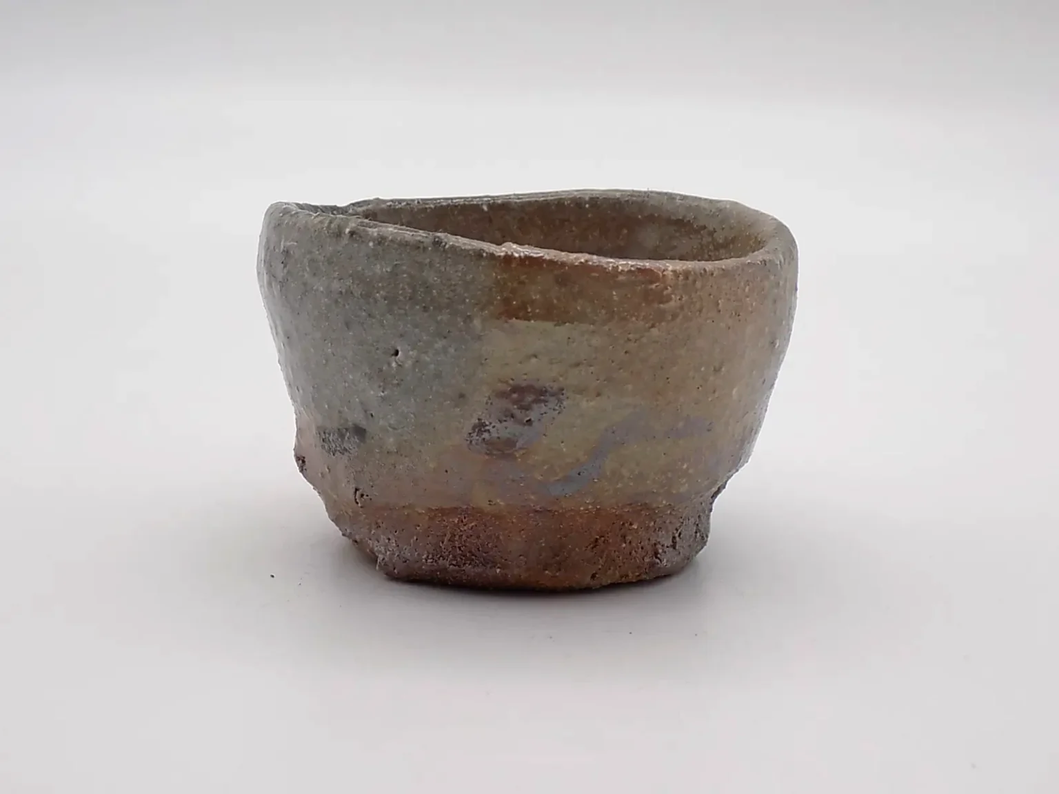 Sake cup with orange ash glaze, side view by Timi Lantos Ceramics