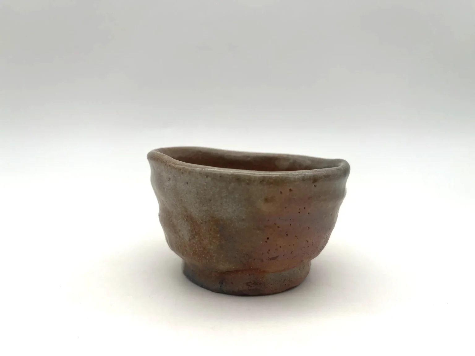 Sake cup with red Shino feldspar glaze, side view by Timi Lantos Ceramics