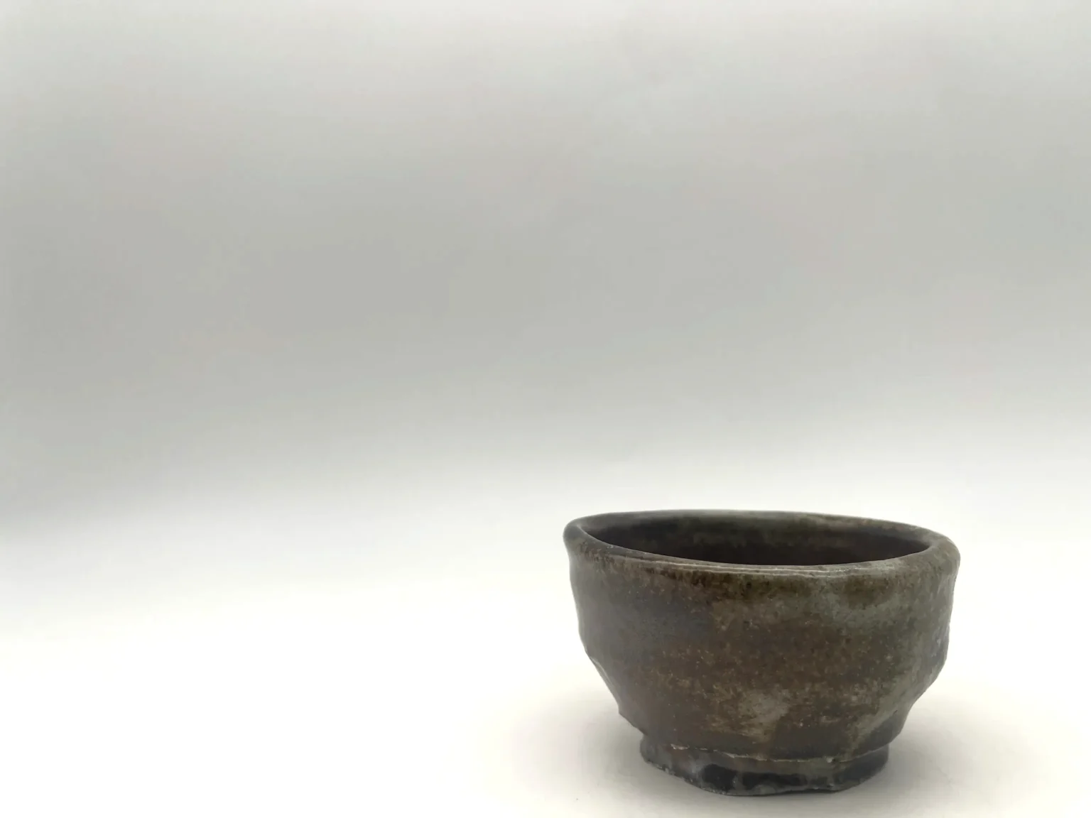 Wood-fired imperfect style sake cup by Timi Lantos Ceramics