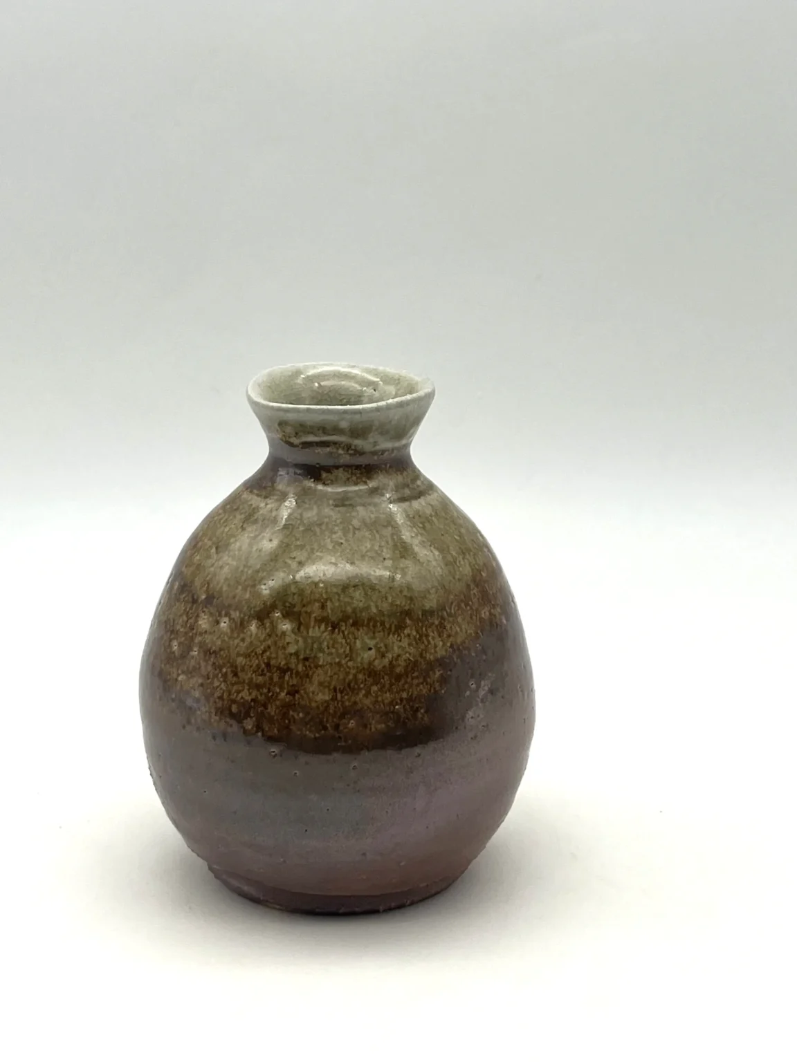 Side view of white anagama fired tokkuri sake bottle by Timi Lantos Ceramics