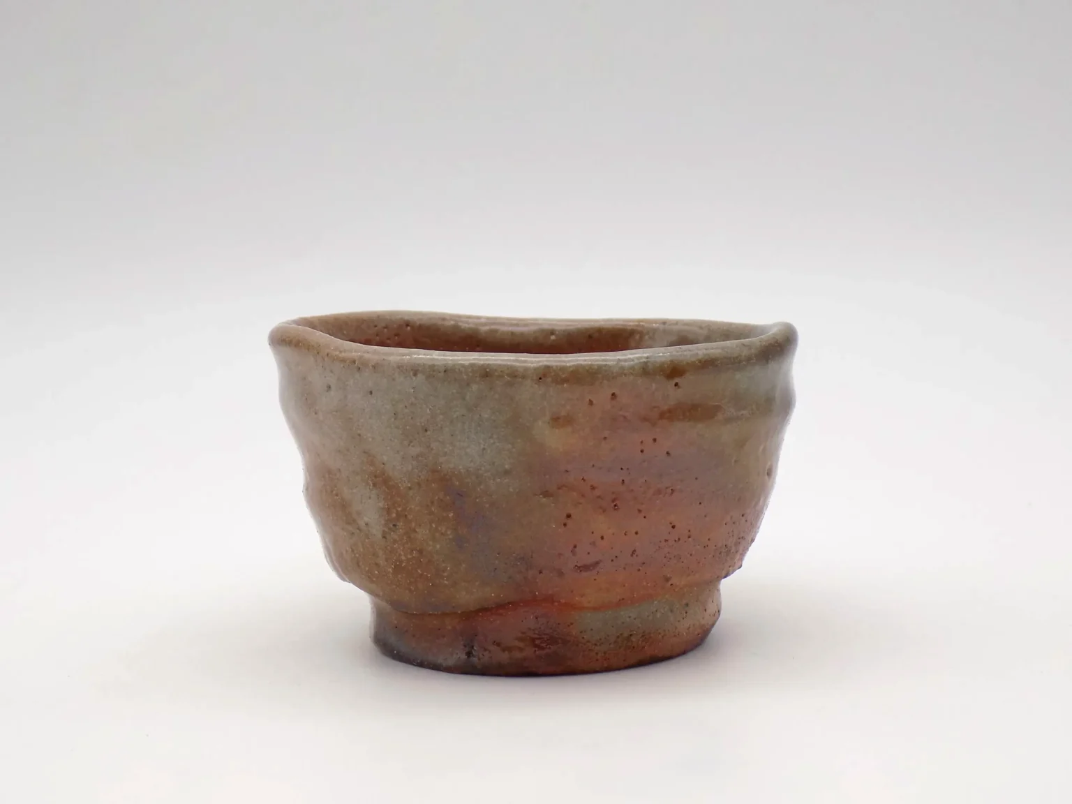 Wheel-thrown ochoko with feldspar glaze and blush tones by Timi Lantos Ceramics