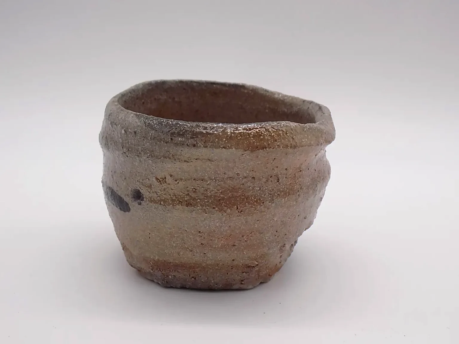 Wheel-thrown ochoko in orange and brown, zoom view by Timi Lantos Ceramics