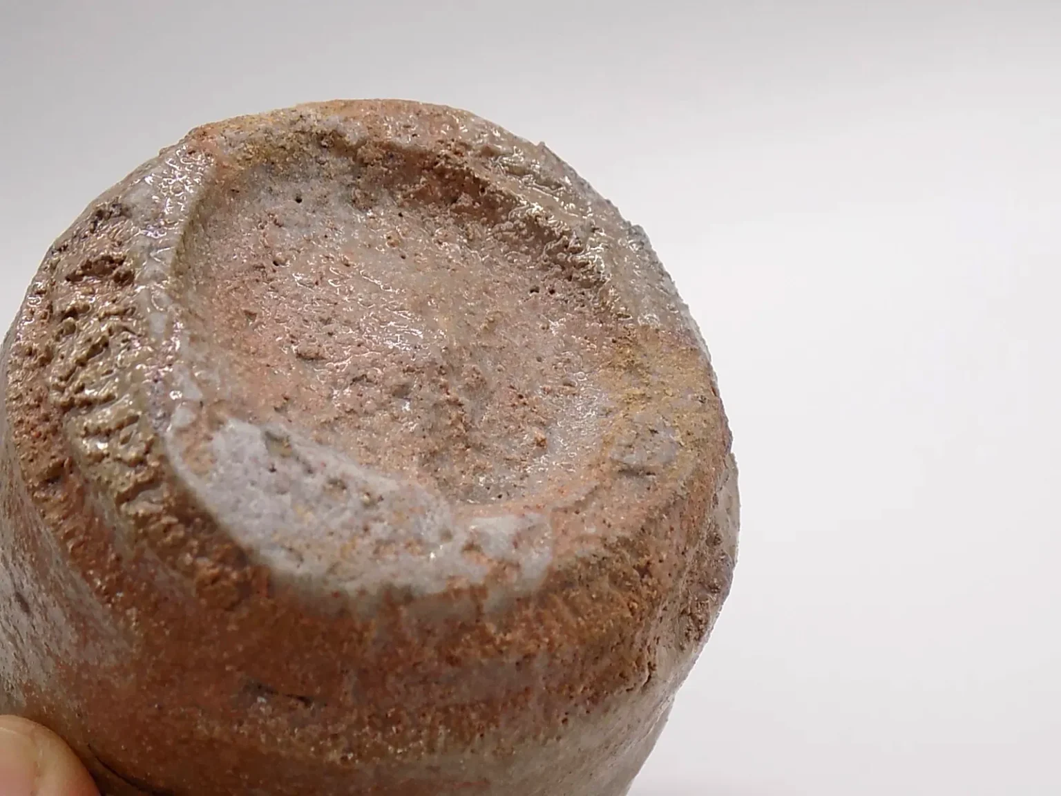 Wheel-thrown sandy earthy ochoko, bottom view by Timi Lantos Ceramics