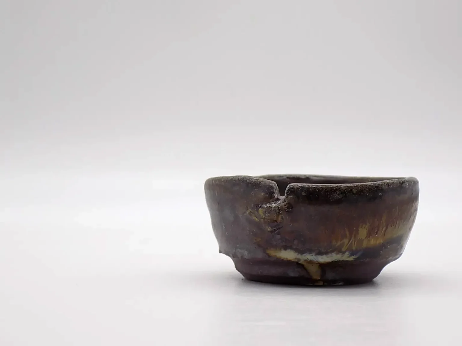 Wheel-thrown sake cup with ash glaze, rim view by Timi Lantos Ceramics