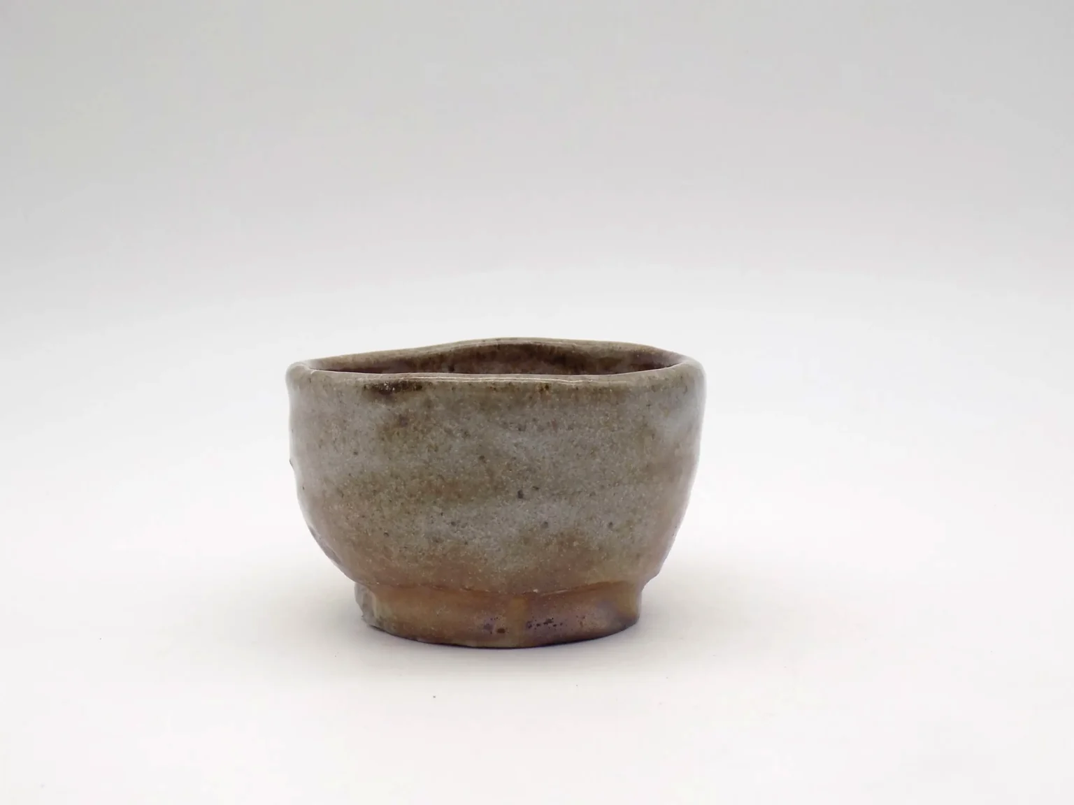 Wheel-thrown sake cup with ash glaze by Timi Lantos Ceramics