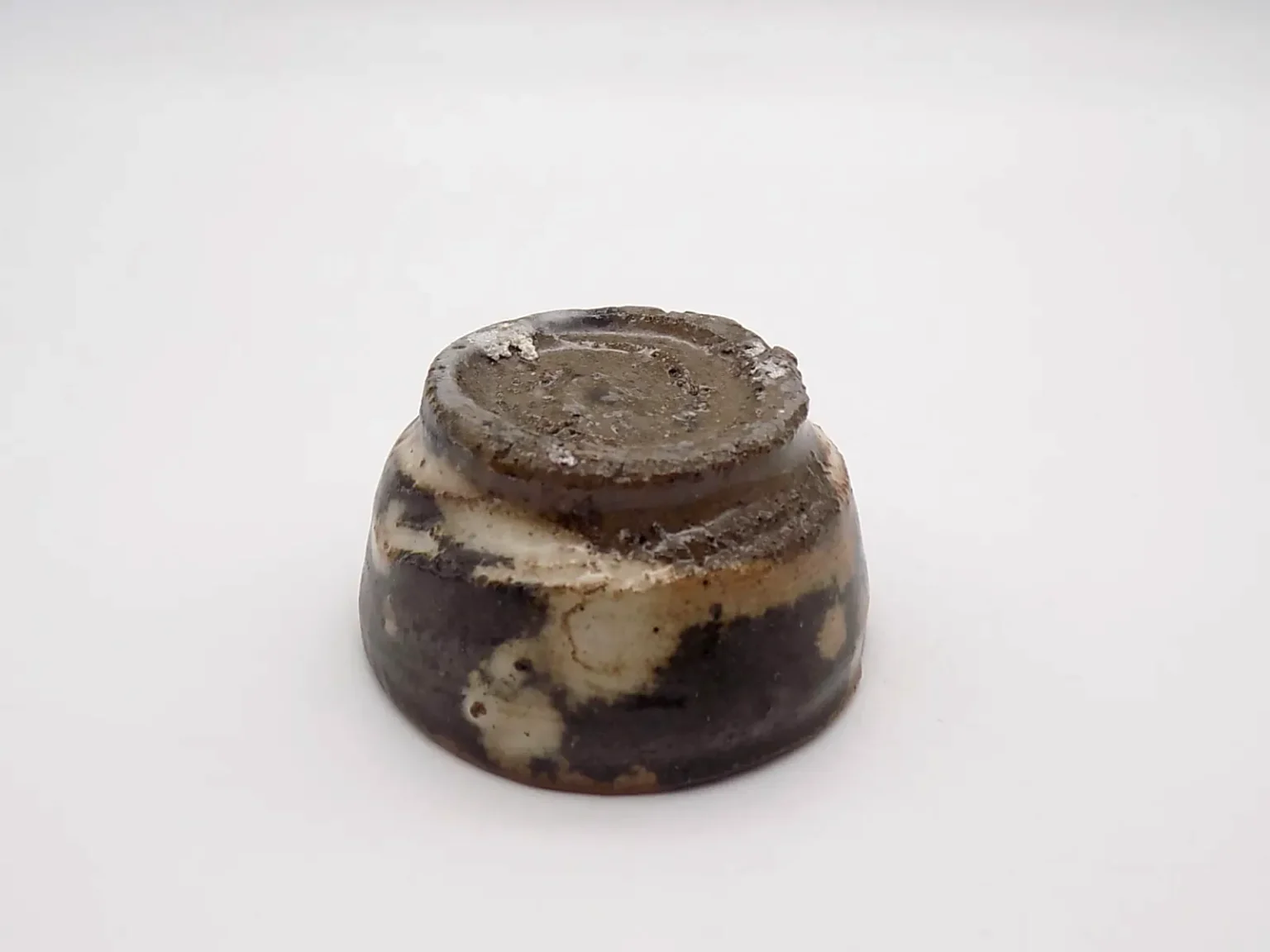 Wheel-thrown brown sake cup, bottom view by Timi Lantos Ceramics