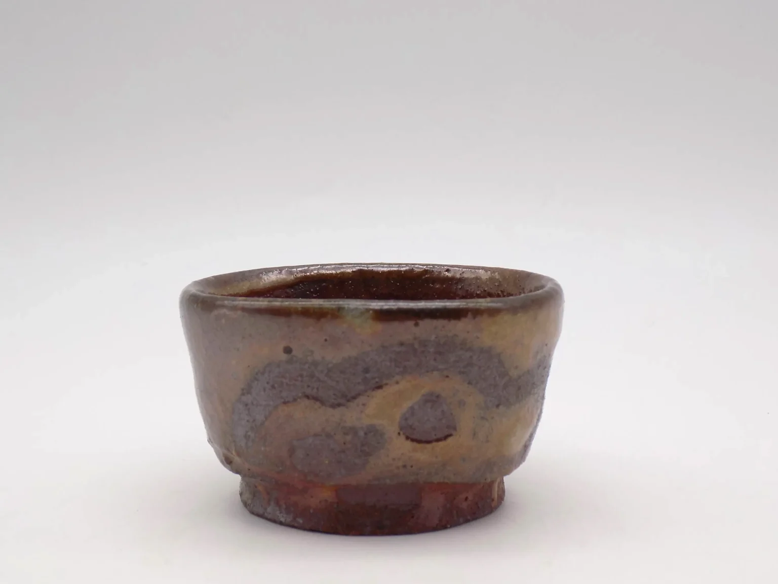 Wheel-thrown sake cup with feldspar glaze, side view by Timi Lantos Ceramics