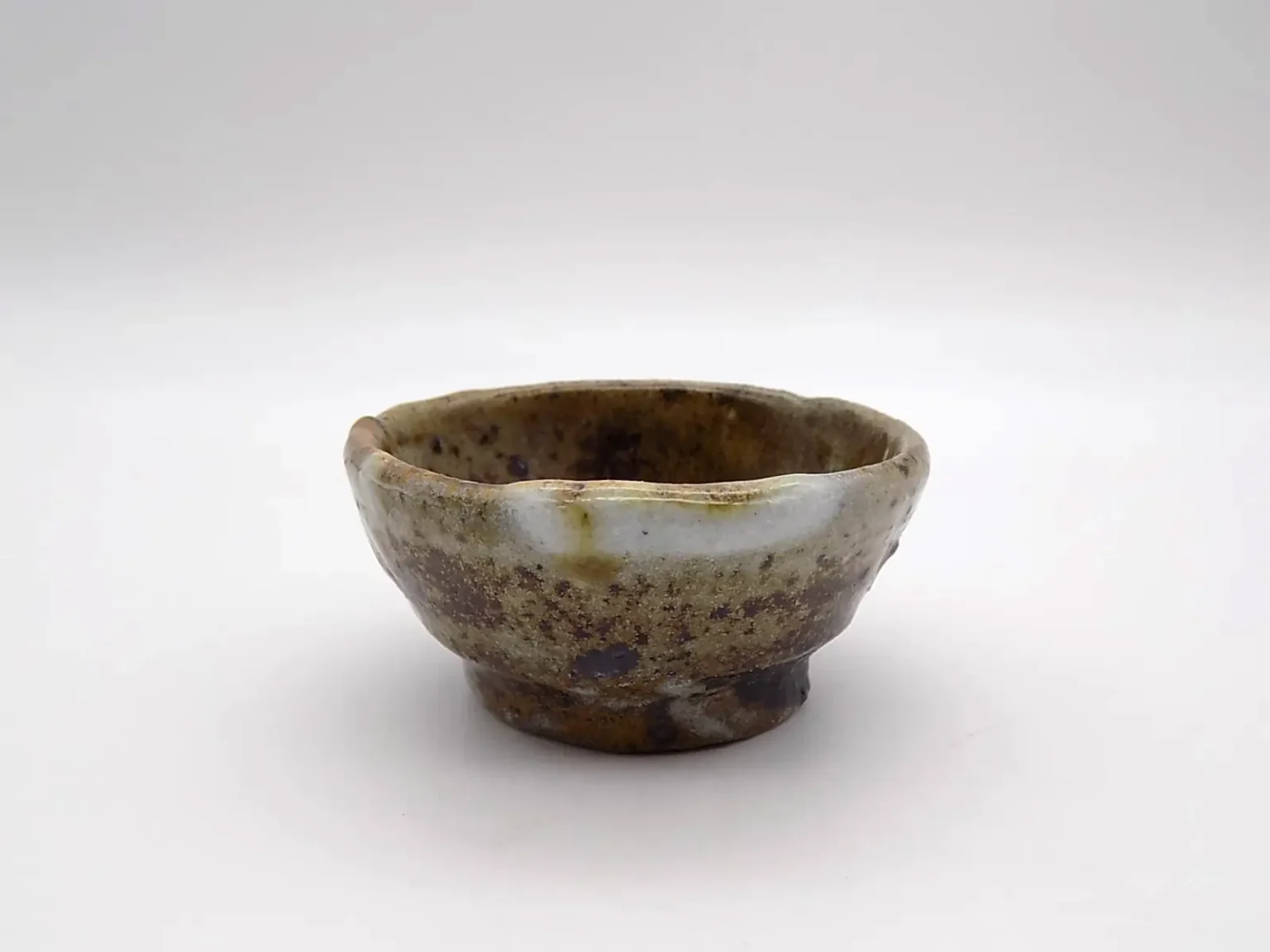Wheel thrown sake cup in wabi-sabi style side view by Timi Lantos Ceramics