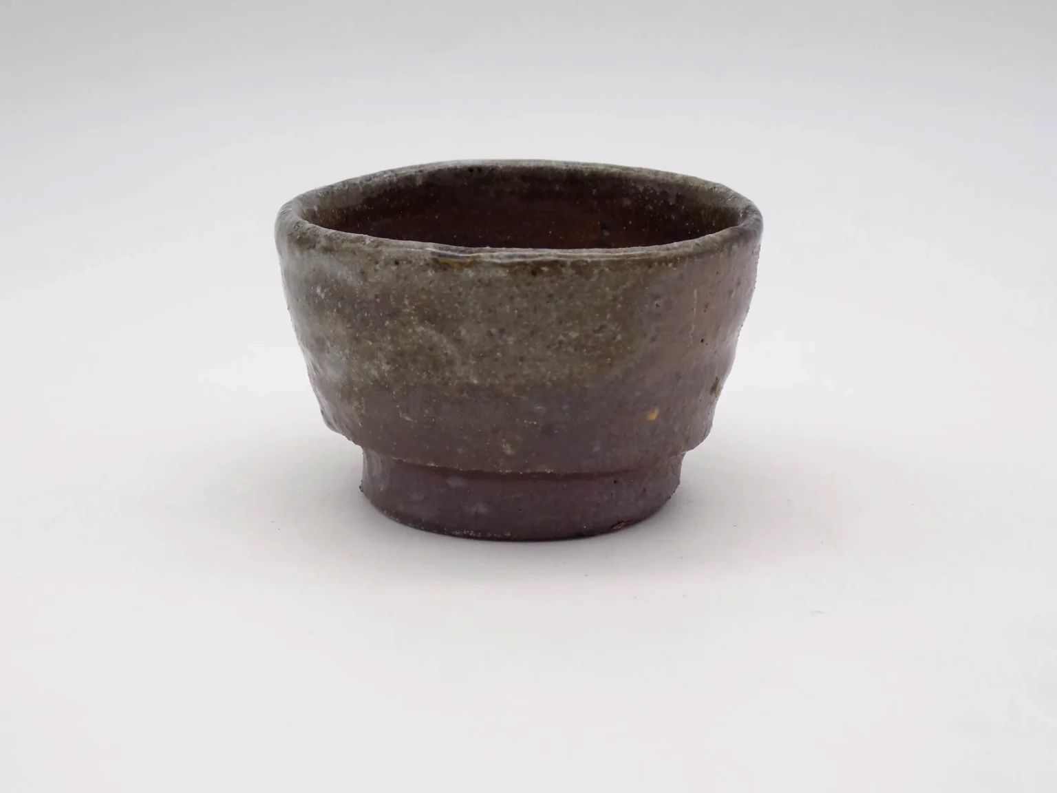 Wood-fired ochoko with feldspar glaze, side view by Timi Lantos Ceramics