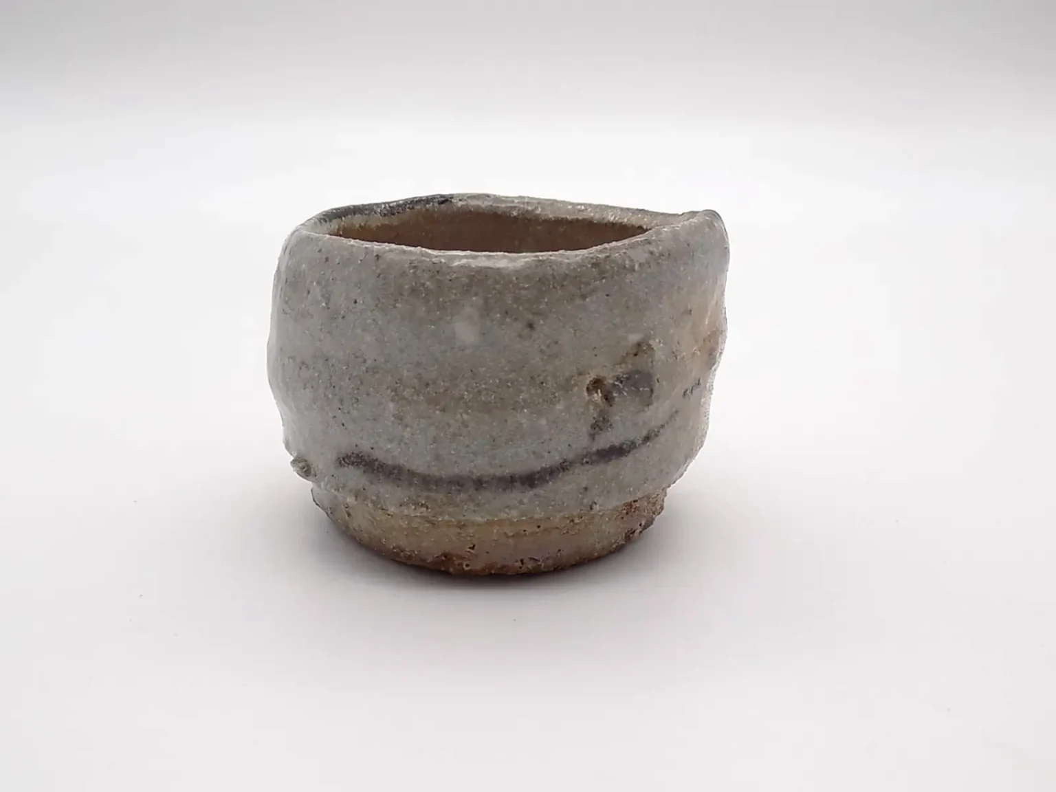 Wood-fired sake cup with ash orange and brown tones, side view by Timi Lantos Ceramics
