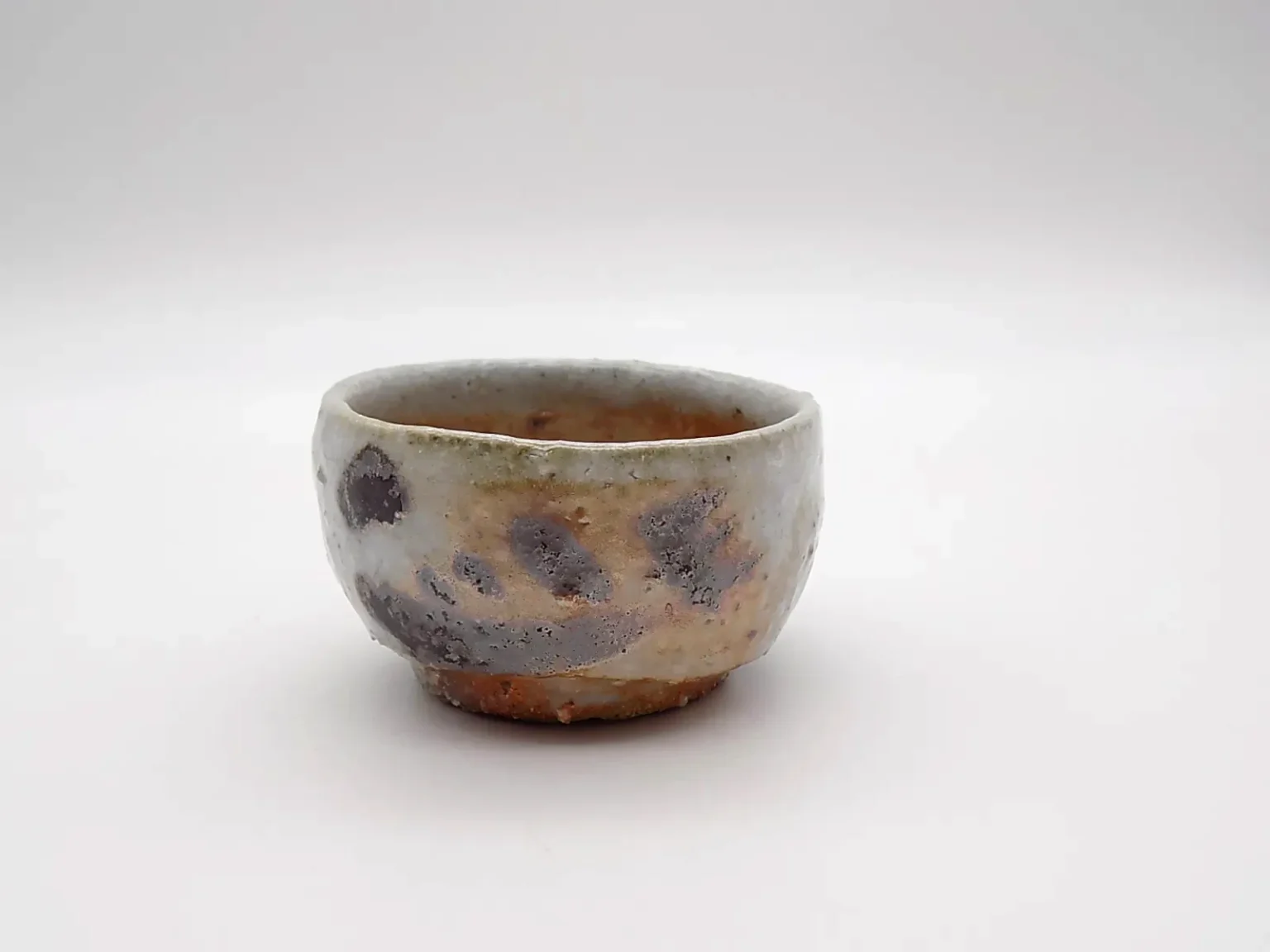 wood fired sake cup feldspar shino glaze side view by Timi Lantos Ceramics