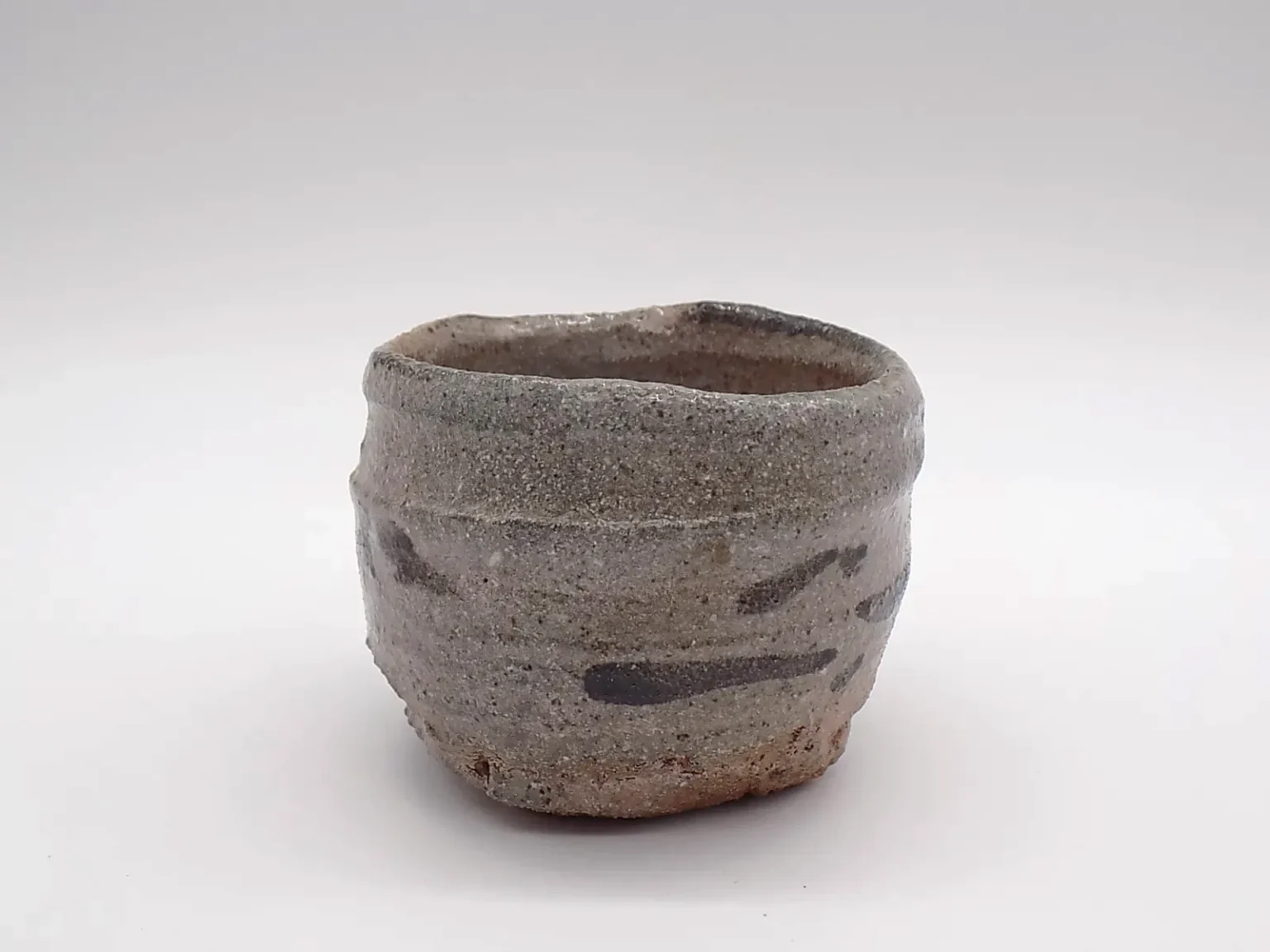 Wood-fired sake cup with sandy feldspar glaze, side view by Timi Lantos Ceramics