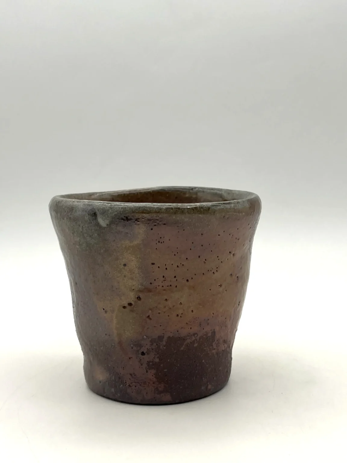 Hand thrown sake cup with red and rusty tones by Timi Lantos Ceramics