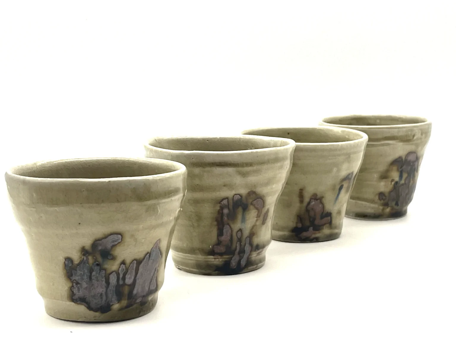 Wood fired sake cups in earthy beige tones by Timi Lantos Ceramics