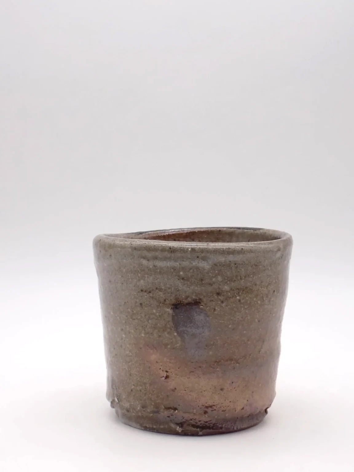 Wood fired sake tea cup in grey and rust tones by Timi Lantos Ceramics