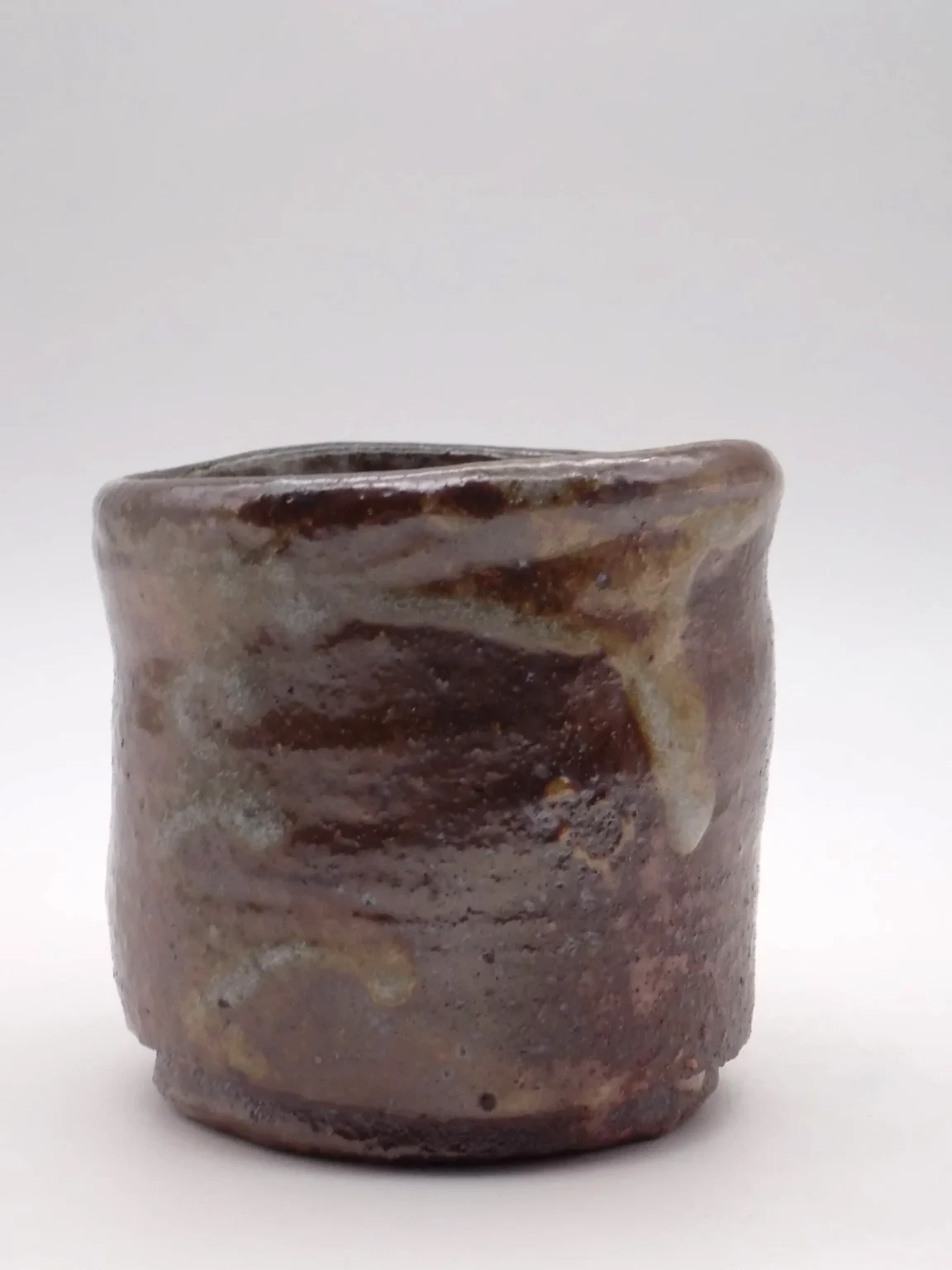 Handmade wood fired tea cup with orange and rusty tones by Timi Lantos Ceramics