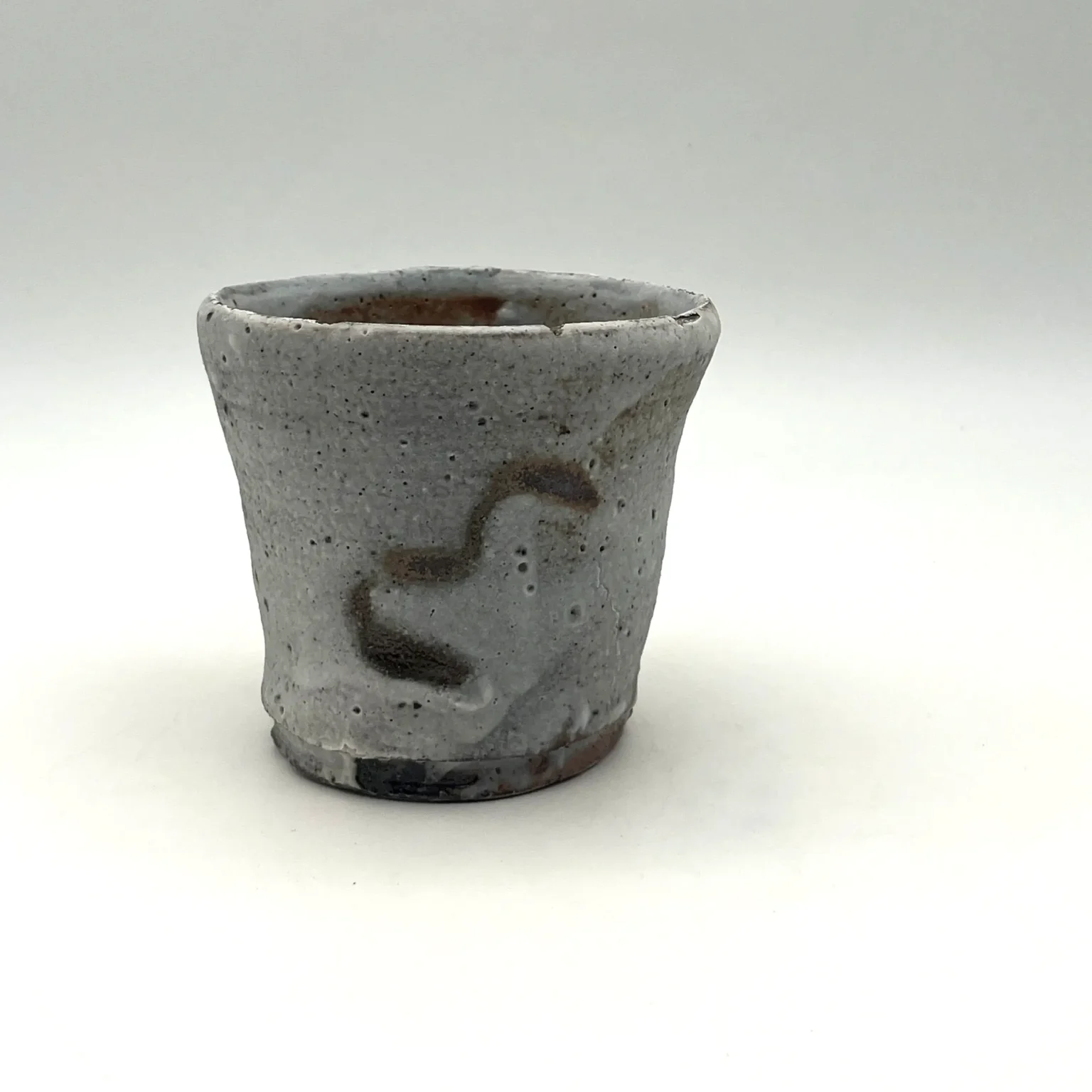 Side view of a white wabi-sabi style ceramic tea cup by Timi Lantos Ceramics
