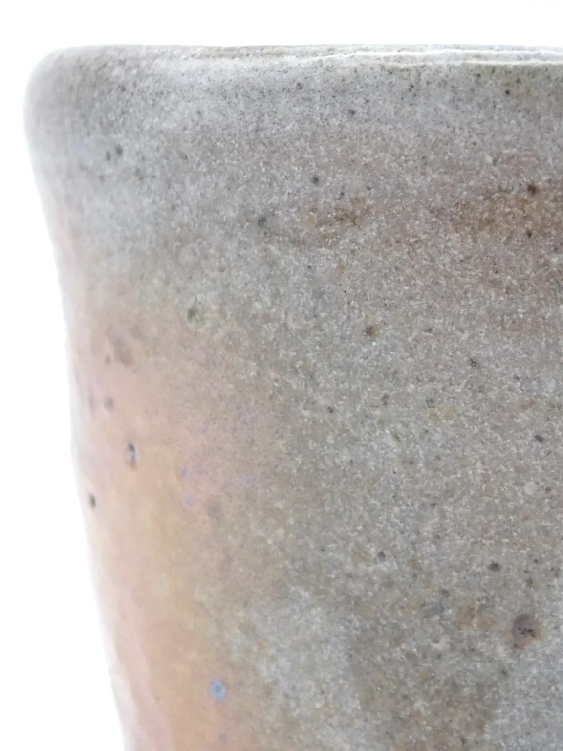 rim of tea woodfired orange tea cup with rusty orange texture