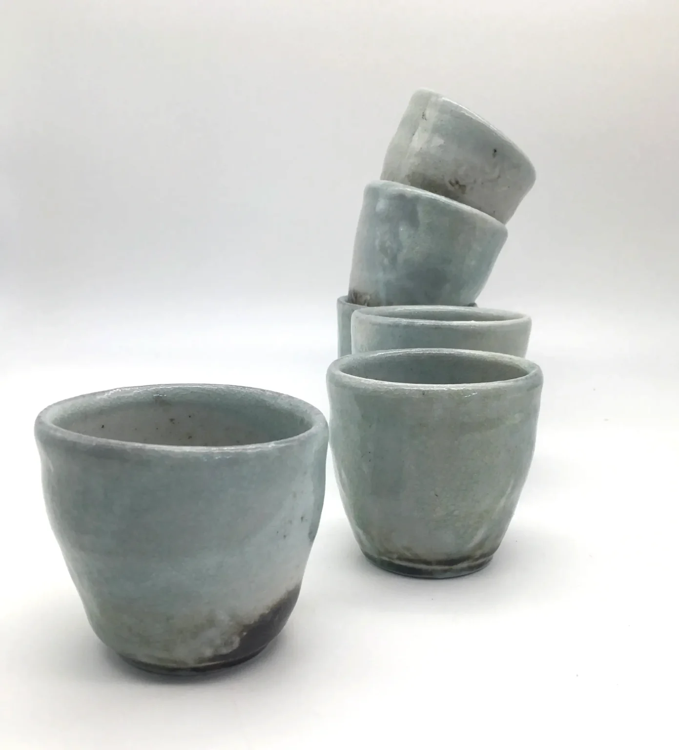Group view of wood fired yunomi tea cups by Timi Lantos Ceramics