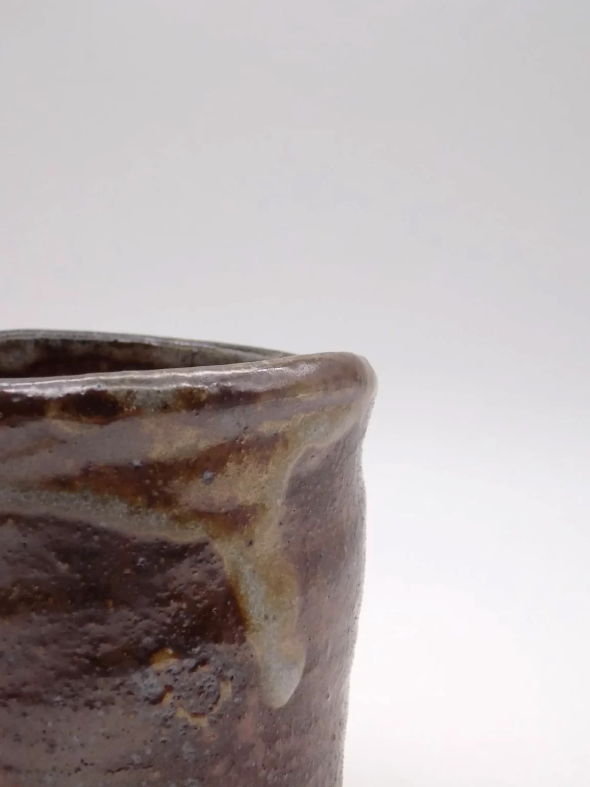 Wood fired yunomi tea cup with ash rim and glossy fire marks by Timi Lantos Ceramics